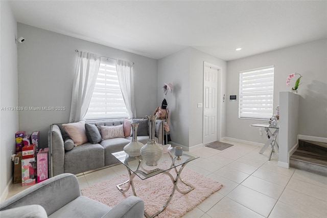 3289 W 106th Ter, Hialeah, FL 33018 - living area with light tile patterned flooring, a healthy amount of sunlight, and baseboards