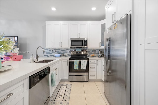3289 W 106th Ter, Hialeah, FL 33018 - kitchen featuring a sink, white cabinets, appliances with stainless steel finishes, and tasteful backsplash