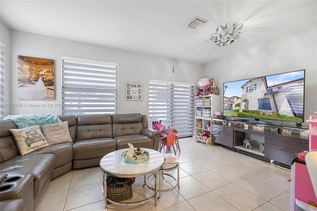 3289 W 106th Ter, Hialeah, FL 33018 - living room with visible vents, light tile patterned floors, and an inviting chandelier