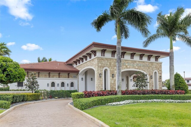 3289 W 106th Ter, Hialeah, FL 33018 - view of front of property featuring a front yard, stone siding, stucco siding, and curved driveway