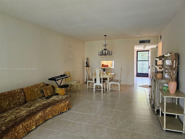 1103 NW 58th Ter Unit 321, Sunrise, FL 33313 - living room featuring tile patterned floors, a chandelier, and a textured ceiling