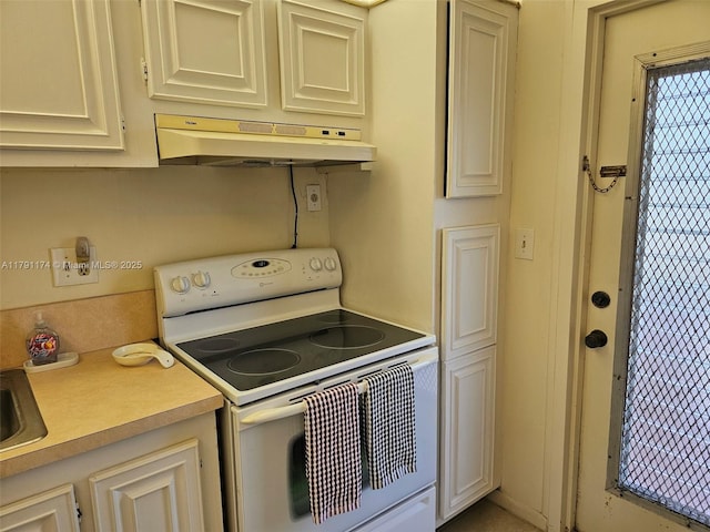 1103 NW 58th Ter Unit 321, Sunrise, FL 33313 - kitchen with white electric range, under cabinet range hood, light countertops, and cream cabinetry