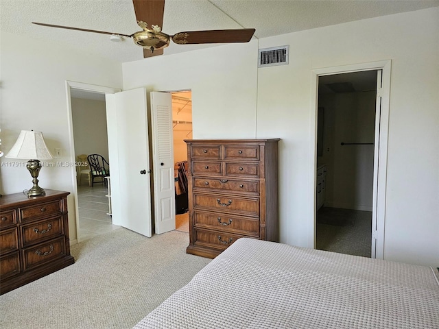 1103 NW 58th Ter Unit 321, Sunrise, FL 33313 - bedroom with a walk in closet, a closet, light carpet, ensuite bathroom, and ceiling fan