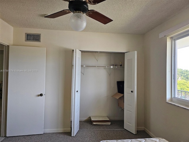 1103 NW 58th Ter Unit 321, Sunrise, FL 33313 - unfurnished bedroom featuring a closet, carpet flooring, a textured ceiling, baseboards, and ceiling fan