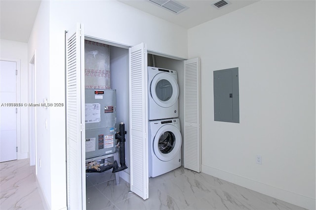 2000 Metropica Way Unit 2605, Sunrise, FL 33323 - laundry room with electric panel, stacked washer and clothes dryer, marble look tile flooring, and baseboards