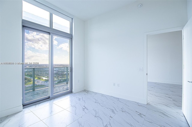 2000 Metropica Way Unit 2605, Sunrise, FL 33323 - unfurnished room featuring marble look tile flooring and baseboards