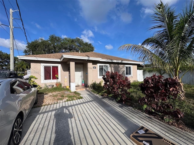 8297 NW 12th Pl, Miami, FL 33147 - view of front of property featuring stucco siding and fence