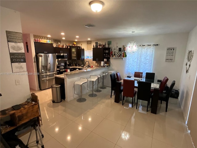 8297 NW 12th Pl, Miami, FL 33147 - dining space featuring light tile patterned floors and recessed lighting