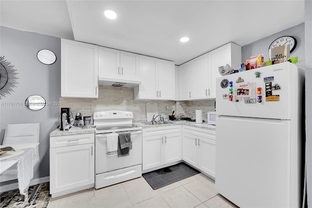 kitchen with light countertops, white cabinetry, white appliances, and tasteful backsplash