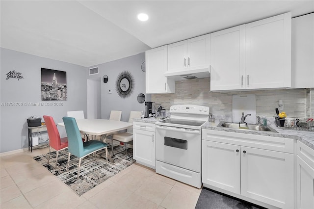 kitchen with electric range, a sink, tasteful backsplash, under cabinet range hood, and visible vents