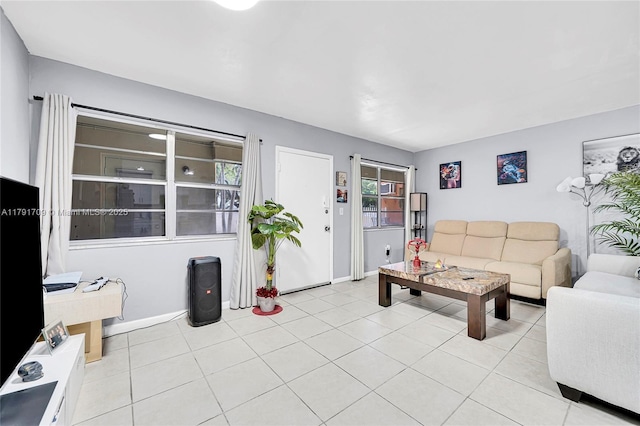 living room with light tile patterned flooring and baseboards
