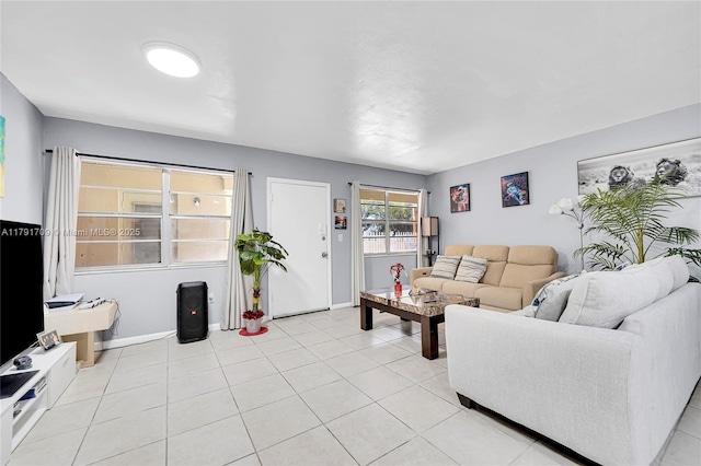 living room featuring light tile patterned flooring and baseboards