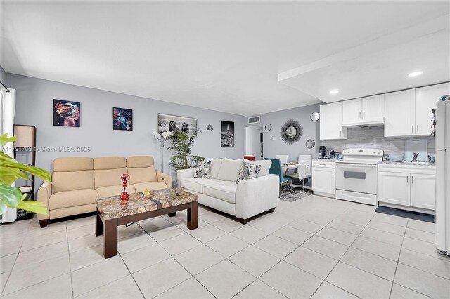 living room featuring recessed lighting, visible vents, and light tile patterned floors