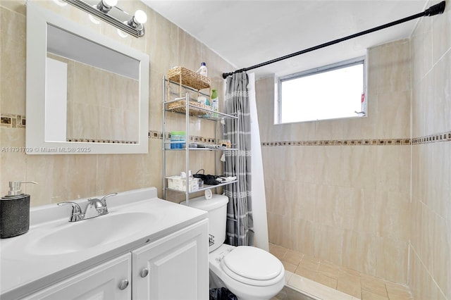 full bath with toilet, tiled shower, and vanity