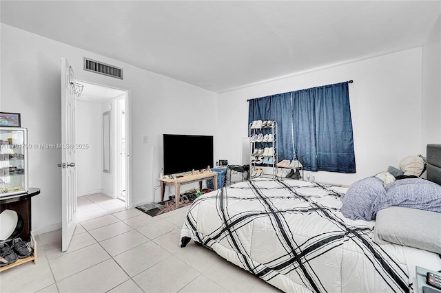 bedroom featuring visible vents and light tile patterned floors