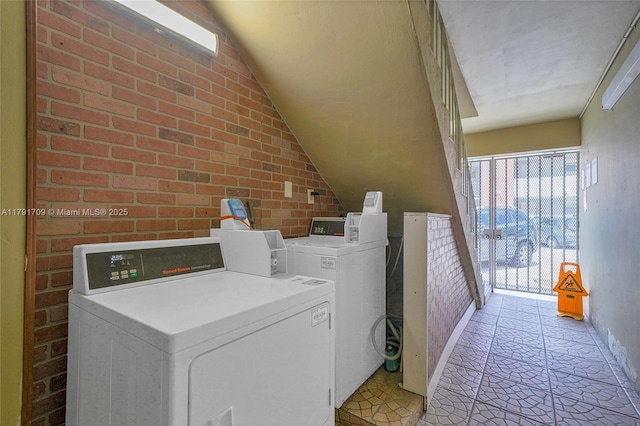 common laundry area featuring separate washer and dryer and baseboards