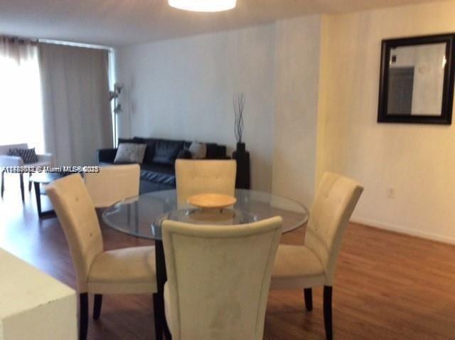 200 178th Dr Unit 504, Sunny Isles Beach, FL 33160 - dining area featuring wood finished floors and baseboards