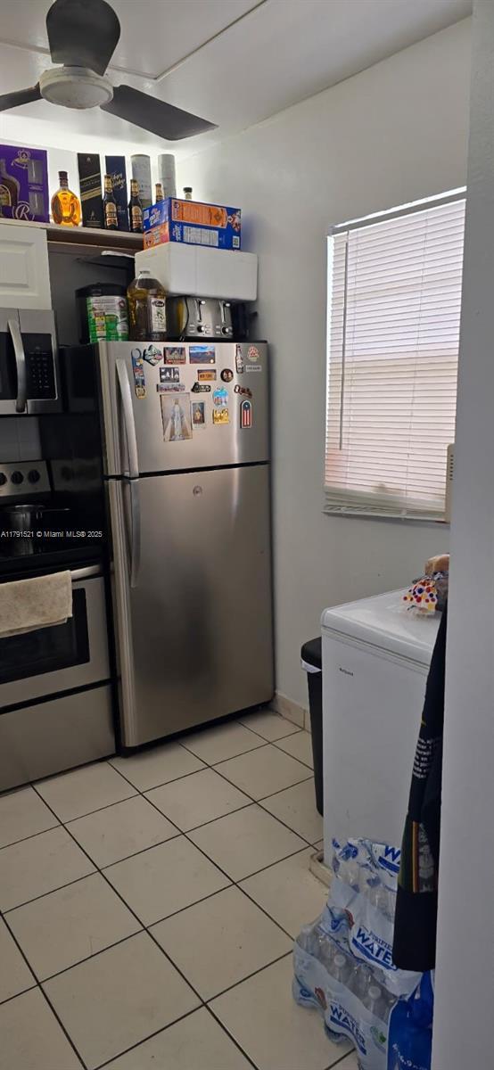 4805 NW 35th St Unit 610, Lauderdale Lakes, FL 33319 - kitchen with appliances with stainless steel finishes, ceiling fan, and light tile patterned floors