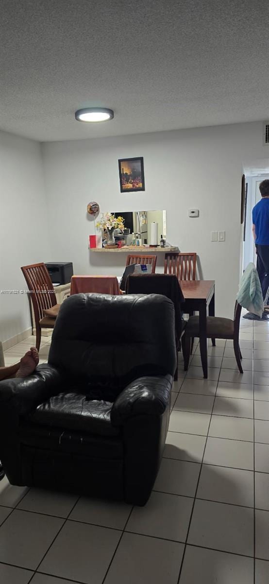 4805 NW 35th St Unit 610, Lauderdale Lakes, FL 33319 - living room with light tile patterned floors and a textured ceiling