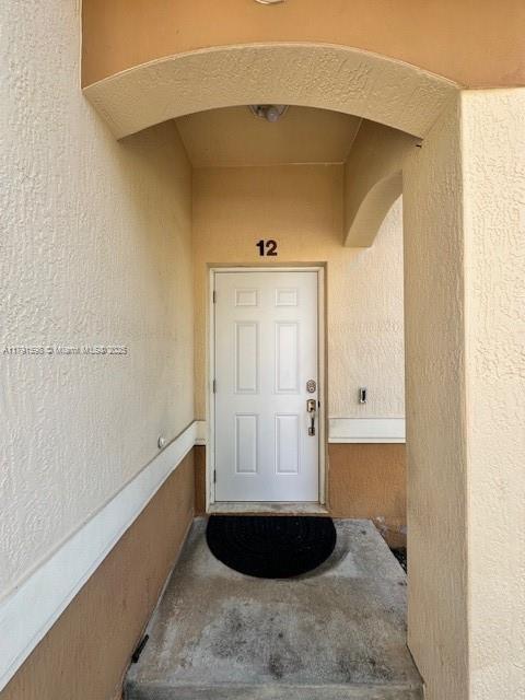 212 NE 3rd St Unit 12, Hallandale Beach, FL 33009 - property entrance with stucco siding