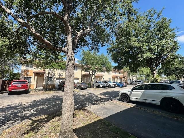 212 NE 3rd St Unit 12, Hallandale Beach, FL 33009 - exterior space with a residential view, stucco siding, and uncovered parking