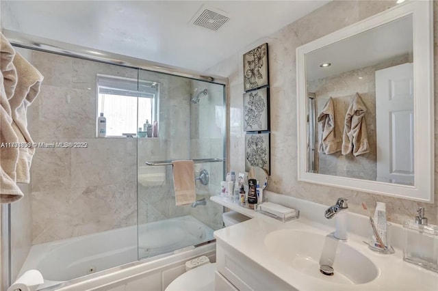 full bathroom with enclosed tub / shower combo, visible vents, toilet, and vanity