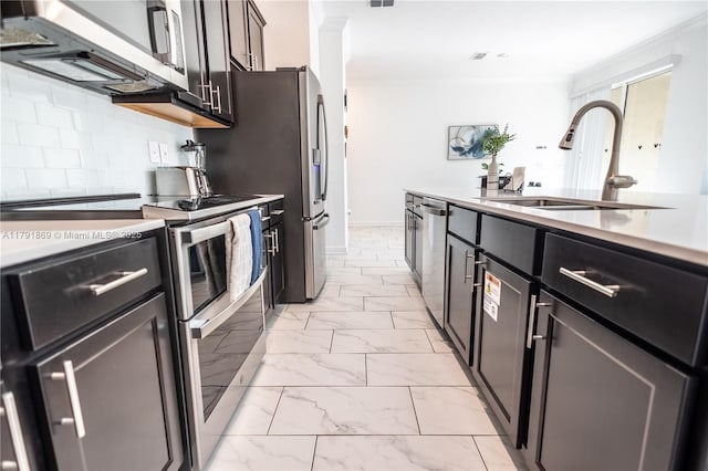 kitchen with tasteful backsplash, a sink, stainless steel appliances, light countertops, and marble finish floor
