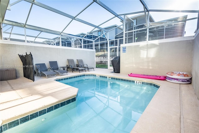 outdoor pool featuring a lanai and a patio area