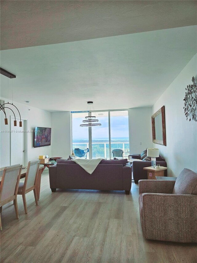 living room with a chandelier and light wood-style flooring