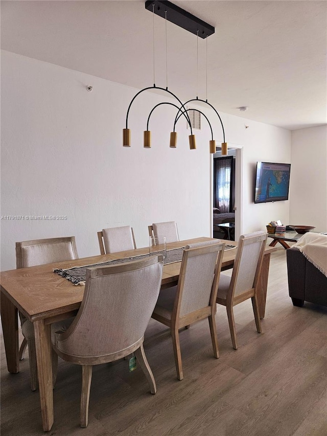 dining room with an inviting chandelier and wood finished floors