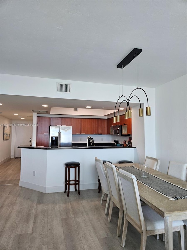 dining area featuring visible vents, recessed lighting, and light wood-style flooring