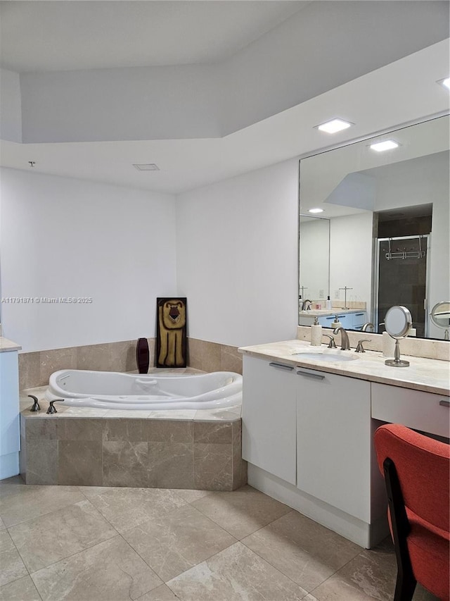 full bathroom featuring vanity, a stall shower, and a bath