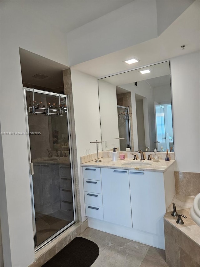 full bath featuring a shower stall, a bath, and vanity