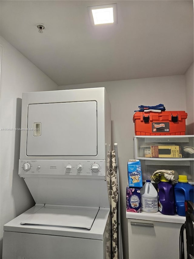clothes washing area with laundry area and stacked washer / dryer