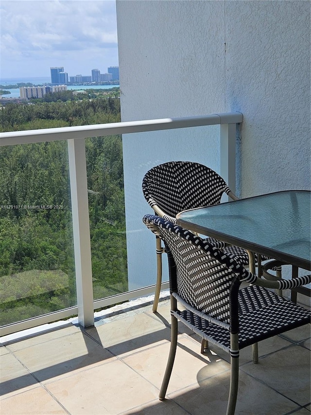 balcony with a view of city and outdoor dining space