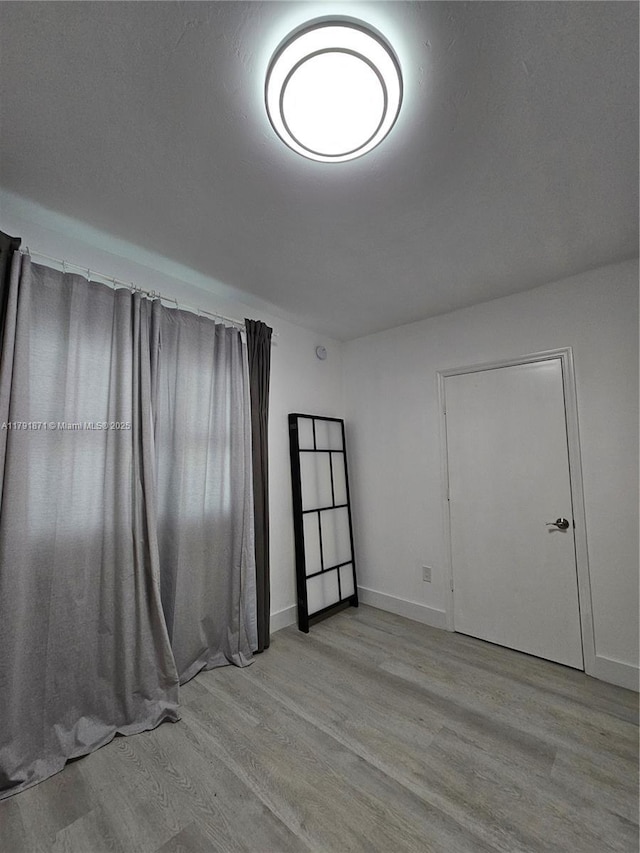15051 Royal Oaks Ln Unit 2202, North Miami, FL 33181 - spare room with light wood-style floors and baseboards