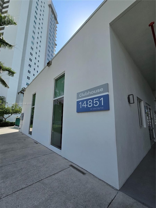 15051 Royal Oaks Ln Unit 2202, North Miami, FL 33181 - view of side of home with stucco siding and a patio