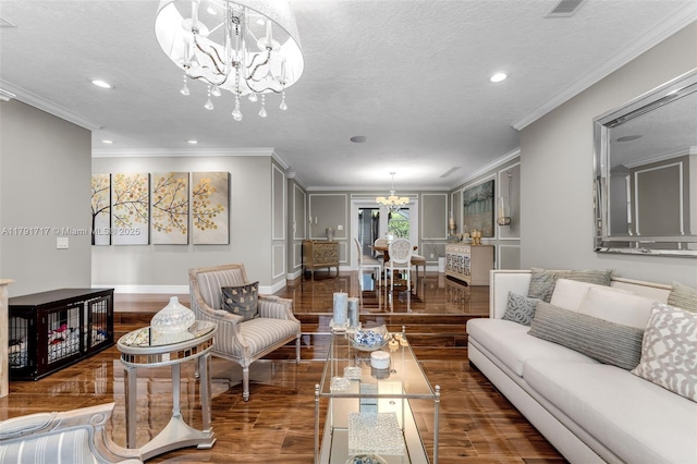 living area with crown molding, an inviting chandelier, and wood finished floors