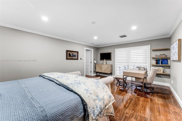 bedroom featuring ornamental molding, visible vents, wood finished floors, and baseboards