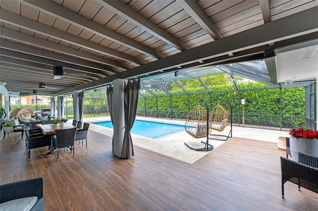 outdoor pool with glass enclosure and outdoor dining area