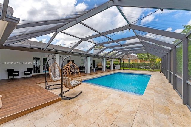 outdoor pool with a lanai and a patio area