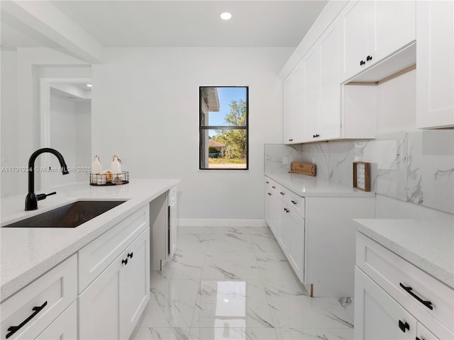 923 Winters St E, Lehigh Acres, FL 33974 - laundry room with recessed lighting, baseboards, marble finish floor, and a sink
