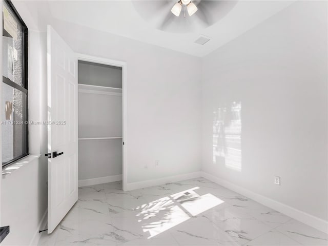 923 Winters St E, Lehigh Acres, FL 33974 - unfurnished bedroom featuring marble finish floor, visible vents, ceiling fan, and baseboards