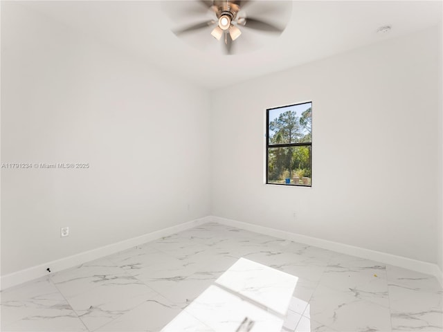 923 Winters St E, Lehigh Acres, FL 33974 - unfurnished room featuring a ceiling fan, marble finish floor, and baseboards