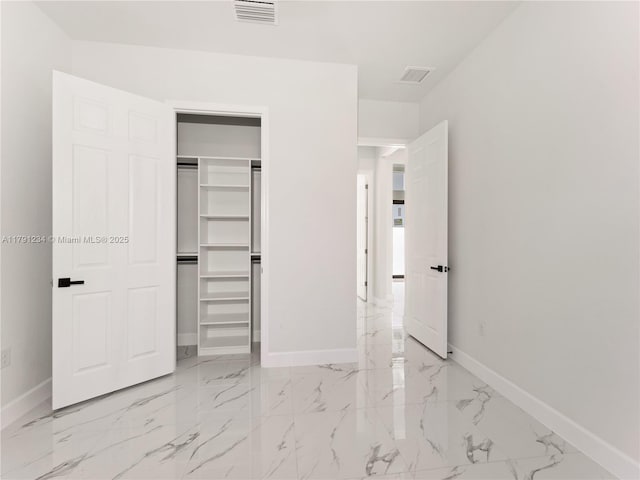 923 Winters St E, Lehigh Acres, FL 33974 - unfurnished bedroom with visible vents, marble finish floor, and baseboards