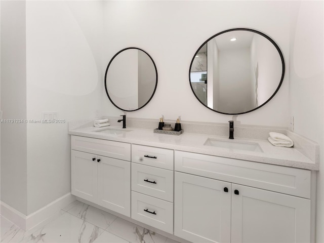 923 Winters St E, Lehigh Acres, FL 33974 - bathroom with marble finish floor, a sink, double vanity, and baseboards