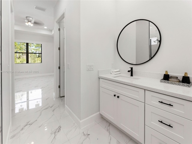 923 Winters St E, Lehigh Acres, FL 33974 - bathroom with marble finish floor, vanity, baseboards, visible vents, and a ceiling fan