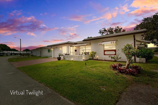 8301 NW 57th Pl, Tamarac, FL 33321 - view of front of house with driveway, a lawn, a garage, and stucco siding