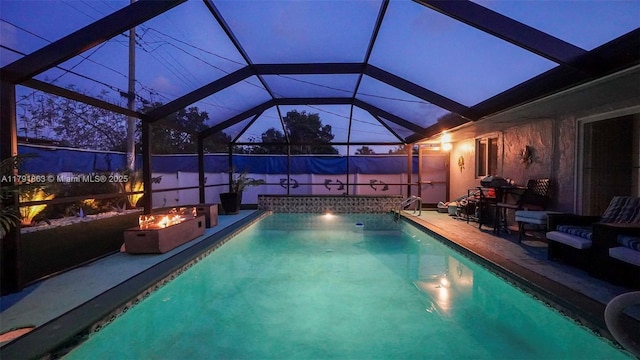 view of pool with a lanai, a fenced in pool, a fire pit, and a patio area