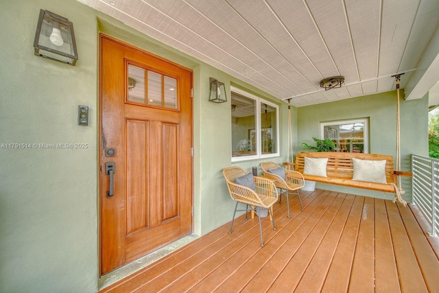 exterior space with a porch and stucco siding